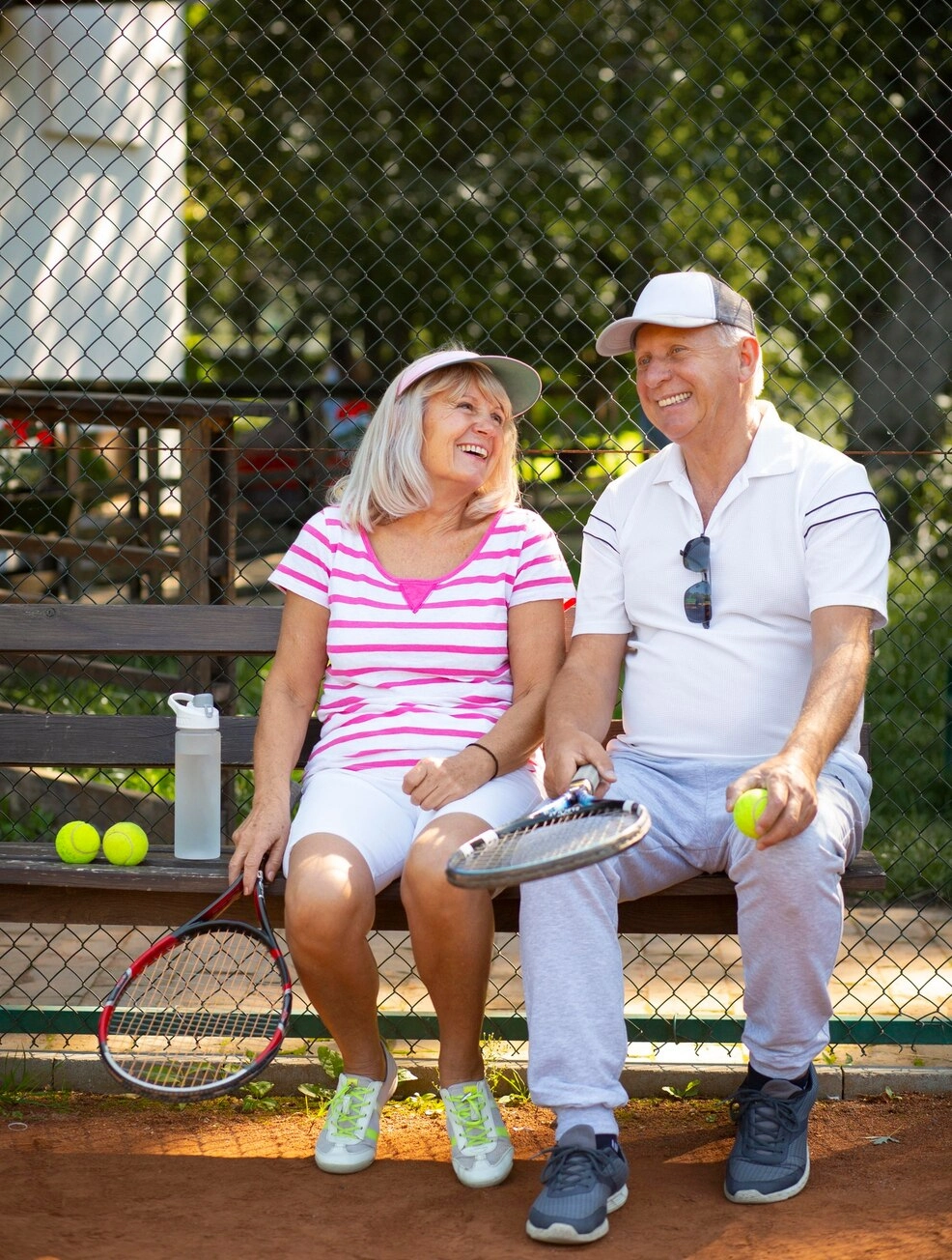 full-shot-smiley-senior-friends-sitting-bench